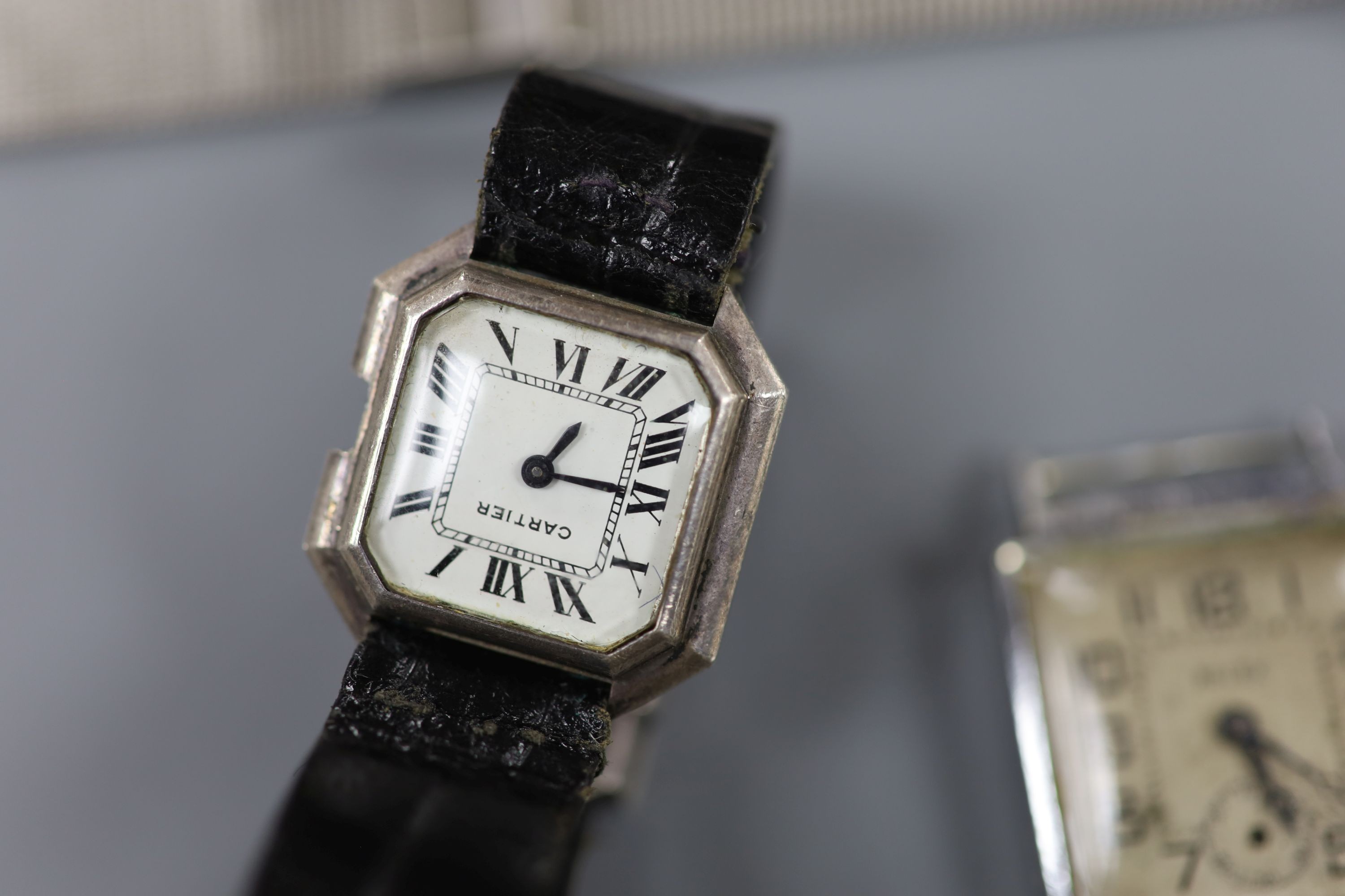 A gentleman's early 20th century silver trench wrist watch by J.W. Benson, four other wrist watches, two silver or white metal fob watches and a wrist watch case.